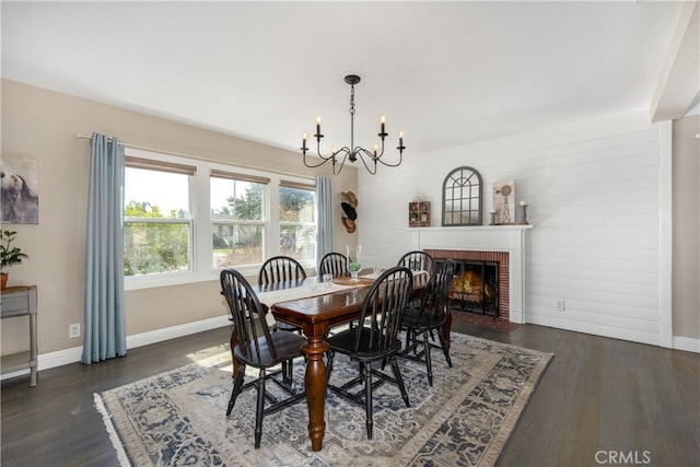 2731 N Rutgers Ave, Long Beach, CA 90815 - dining area featuring a chandelier, baseboards, dark wood-type flooring, and a brick fireplace
