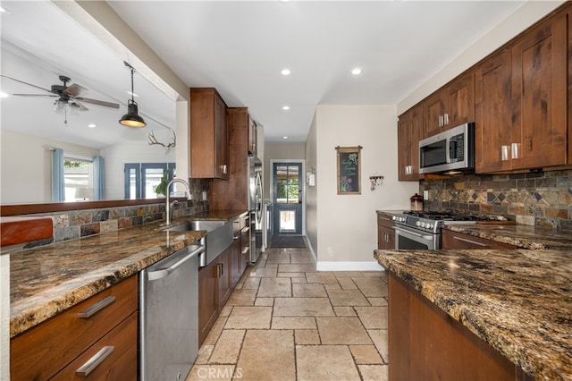 2731 N Rutgers Ave, Long Beach, CA 90815 - kitchen featuring stainless steel appliances, a sink, tasteful backsplash, dark stone counters, and recessed lighting