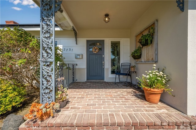 2731 N Rutgers Ave, Long Beach, CA 90815 - doorway to property with stucco siding and covered porch