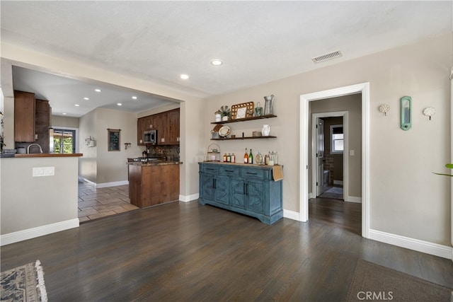 2731 N Rutgers Ave, Long Beach, CA 90815 - bar area featuring stainless steel microwave, recessed lighting, backsplash, baseboards, and dark wood-type flooring