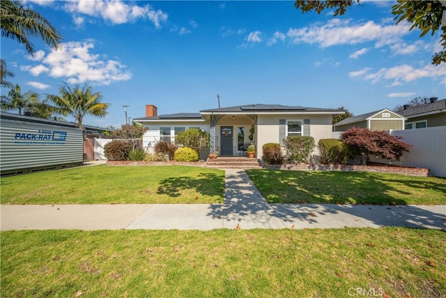 2731 N Rutgers Ave, Long Beach, CA 90815 - view of front of house featuring solar panels, a chimney, and stucco siding