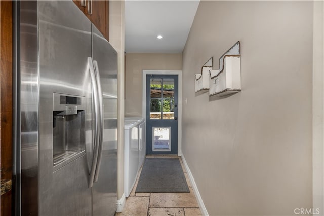 2731 N Rutgers Ave, Long Beach, CA 90815 - doorway with washer and clothes dryer, stone tile flooring, and baseboards