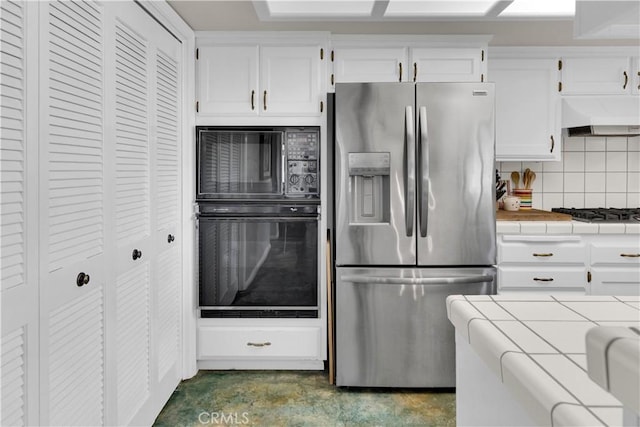 1490 Descanso St Unit 3, San Luis Obispo, CA 93405 - kitchen with black appliances, tile counters, ventilation hood, white cabinetry, and backsplash