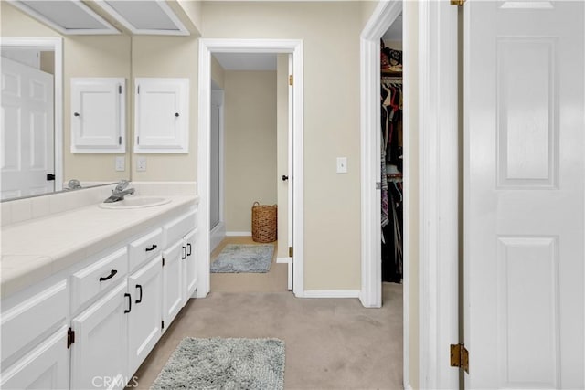 1490 Descanso St Unit 3, San Luis Obispo, CA 93405 - bathroom with vanity, a spacious closet, baseboards, and a stall shower