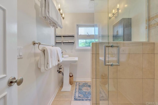 full bathroom featuring a shower stall, tile patterned flooring, and baseboards