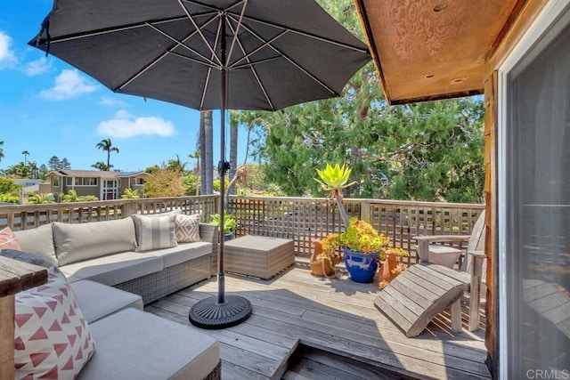 wooden deck with an outdoor living space