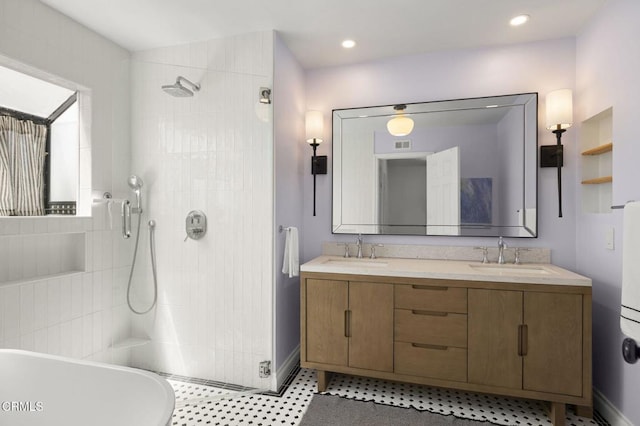 2426 Warbler Ave, Ventura, CA 93003 - full bathroom featuring tiled shower, double vanity, a freestanding tub, and baseboards
