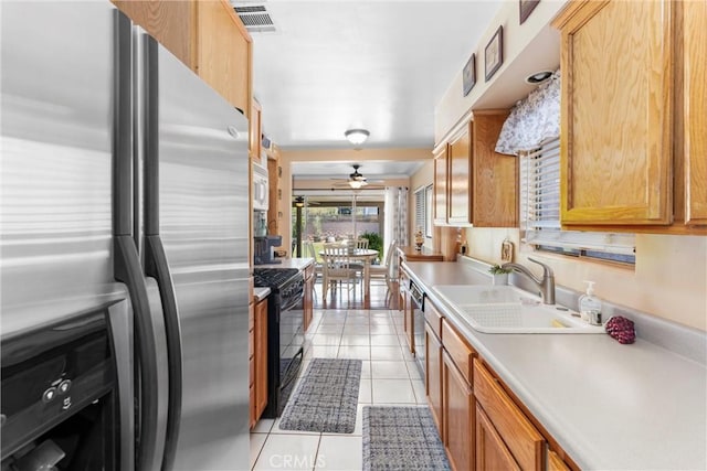 180 N De Lay Ave, Covina, CA 91723 - kitchen featuring stainless steel refrigerator with ice dispenser, gas stove, light tile patterned flooring, light countertops, and a sink