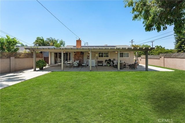 180 N De Lay Ave, Covina, CA 91723 - rear view of house featuring roof mounted solar panels, a chimney, an outdoor hangout area, and a patio
