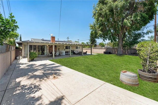 180 N De Lay Ave, Covina, CA 91723 - back of property featuring roof mounted solar panels, a patio area, and a chimney