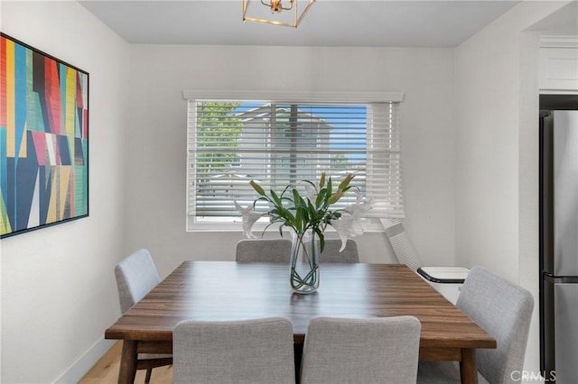 1075 Molino Ave Unit D, Long Beach, CA 90804 - dining room featuring a chandelier, baseboards, and wood finished floors