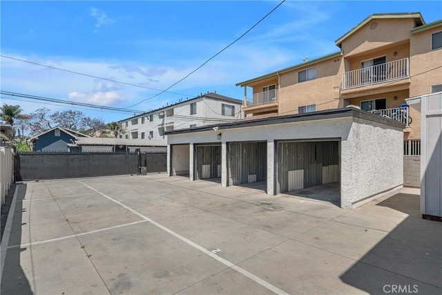 1075 Molino Ave Unit D, Long Beach, CA 90804 - rear view of property featuring stucco siding and fence
