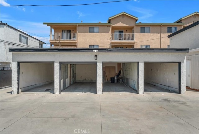 1075 Molino Ave Unit D, Long Beach, CA 90804 - back of property with concrete driveway, a balcony, a garage, and stucco siding