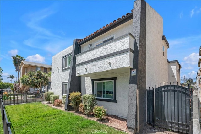 1075 Molino Ave Unit D, Long Beach, CA 90804 - view of side of property featuring stucco siding, a gate, and a tiled roof