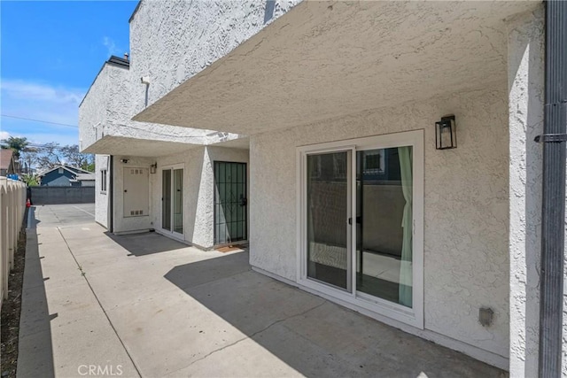 1075 Molino Ave Unit D, Long Beach, CA 90804 - rear view of property with a patio, stucco siding, and fence