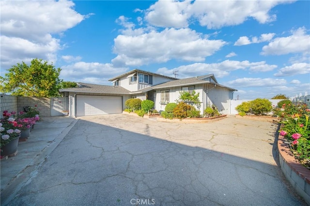 2204 Ruiz Pl, Hacienda Heights, CA 91745 - traditional-style house featuring a garage, asphalt driveway, and fence
