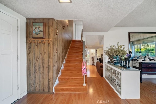 2204 Ruiz Pl, Hacienda Heights, CA 91745 - staircase featuring a textured ceiling, wood finished floors, and wooden walls