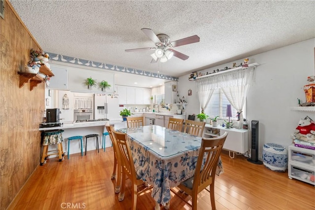 2204 Ruiz Pl, Hacienda Heights, CA 91745 - dining area with light wood-style flooring, a ceiling fan, and a textured ceiling