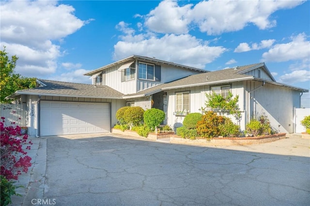 2204 Ruiz Pl, Hacienda Heights, CA 91745 - traditional-style home with driveway, a garage, roof with shingles, and board and batten siding