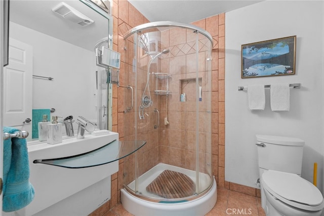 2137 N Murray St, Banning, CA 92220 - full bathroom featuring a shower stall, toilet, tile patterned floors, and vanity