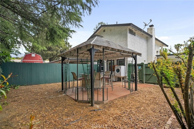 2137 N Murray St, Banning, CA 92220 - back of property with a fenced backyard, a chimney, a patio area, a gate, and a gazebo