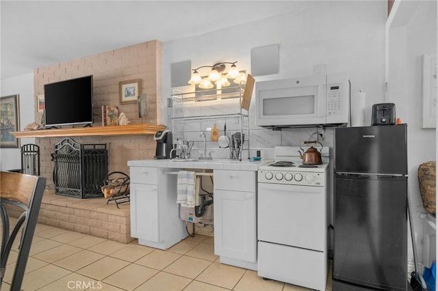 2137 N Murray St, Banning, CA 92220 - kitchen featuring white appliances, tile countertops, a sink, white cabinetry, and light tile patterned floors