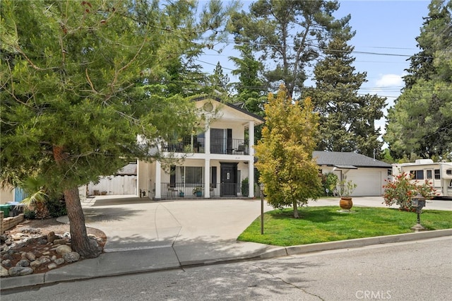2137 N Murray St, Banning, CA 92220 - view of front of home featuring a balcony, concrete driveway, stucco siding, and a garage
