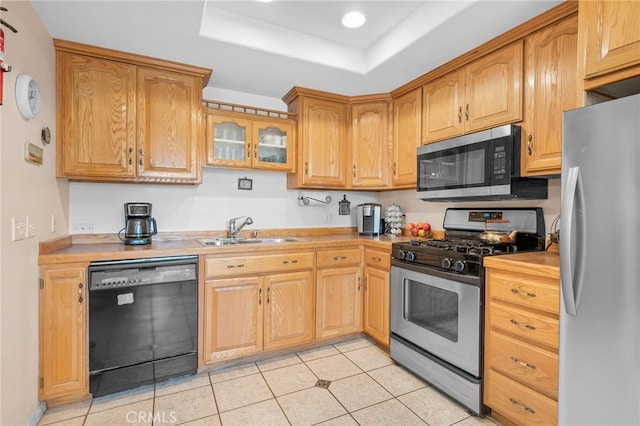 2137 N Murray St, Banning, CA 92220 - kitchen featuring appliances with stainless steel finishes, a sink, light countertops, a raised ceiling, and light tile patterned floors