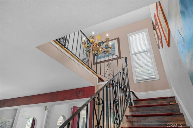 2137 N Murray St, Banning, CA 92220 - staircase featuring a chandelier, plenty of natural light, and baseboards
