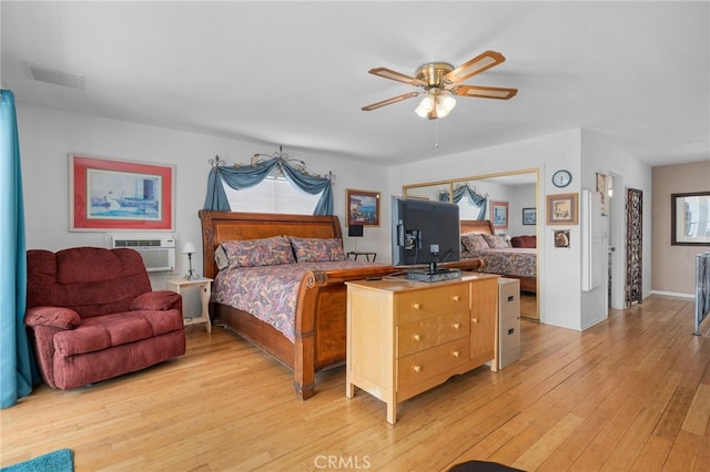 2137 N Murray St, Banning, CA 92220 - bedroom featuring multiple windows, light wood-style flooring, and a wall unit AC