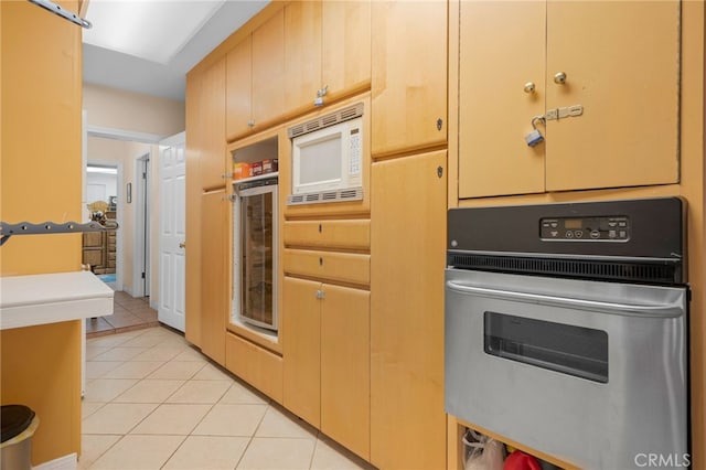 2137 N Murray St, Banning, CA 92220 - kitchen featuring stainless steel oven, light tile patterned floors, white microwave, and beverage cooler