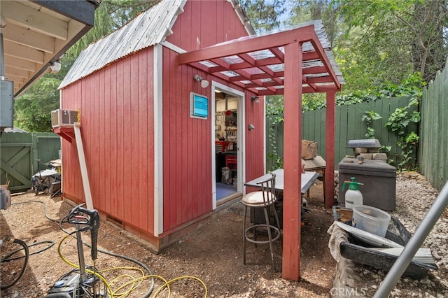 2137 N Murray St, Banning, CA 92220 - view of outdoor structure featuring a fenced backyard, an outdoor structure, and a pergola