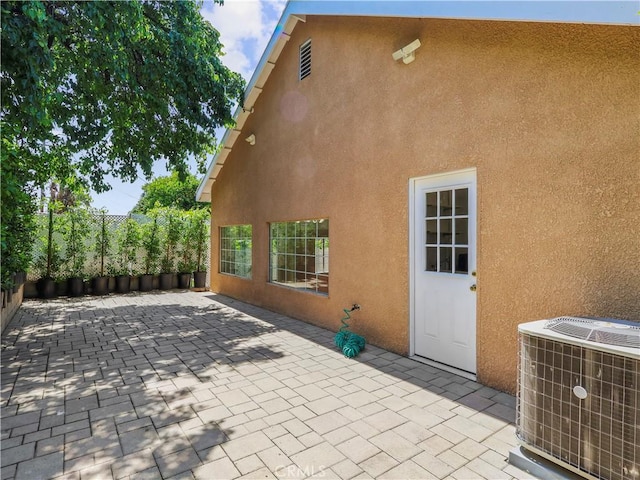 3627 Virginia St, La Crescenta, CA 91214 - rear view of house with central AC unit, stucco siding, a patio, and fence