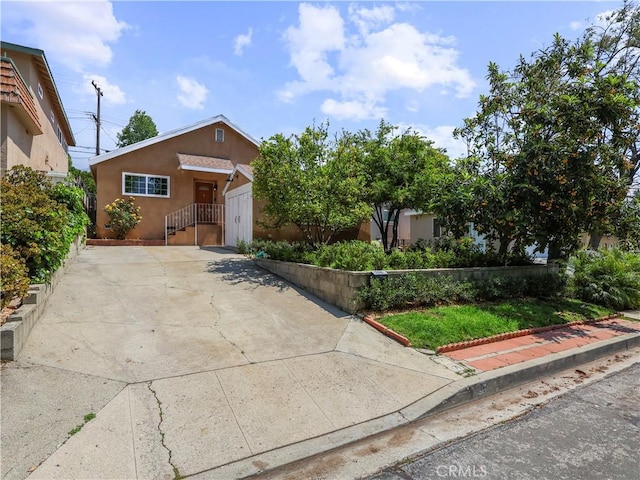 3627 Virginia St, La Crescenta, CA 91214 - view of front of property featuring stucco siding, driveway, and a garage