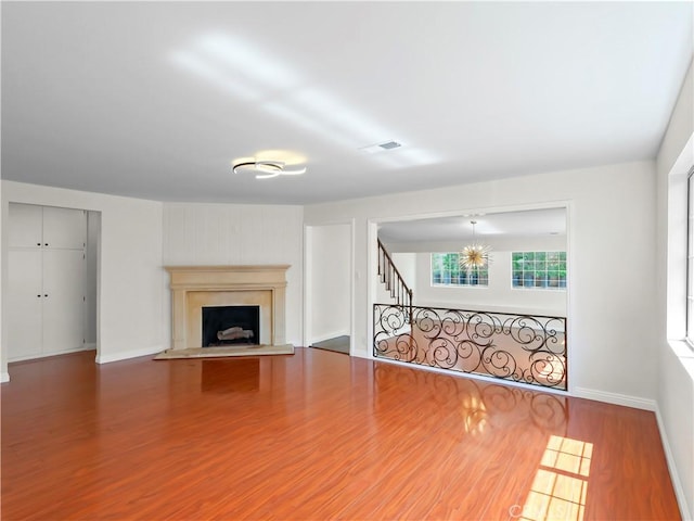 3627 Virginia St, La Crescenta, CA 91214 - unfurnished living room with wood finished floors, a fireplace with raised hearth, and baseboards