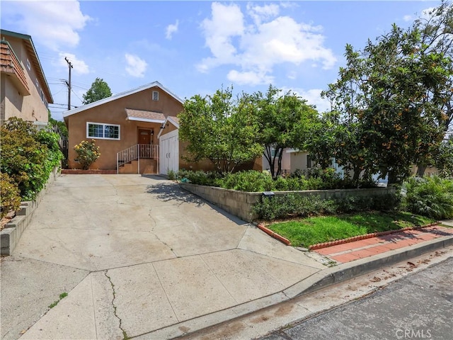 3627 Virginia St, La Crescenta, CA 91214 - view of front of house with stucco siding, concrete driveway, and an attached garage