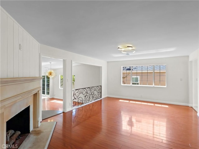 3627 Virginia St, La Crescenta, CA 91214 - unfurnished living room with wood-type flooring, baseboards, and a fireplace with raised hearth