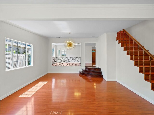 3627 Virginia St, La Crescenta, CA 91214 - unfurnished living room with stairway, wood finished floors, and baseboards