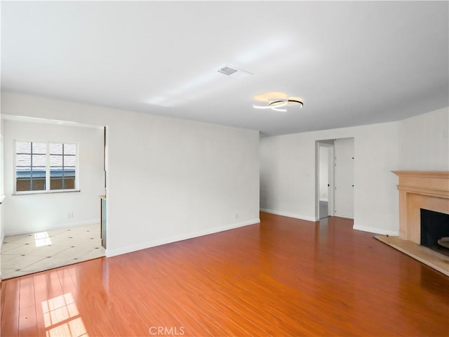 3627 Virginia St, La Crescenta, CA 91214 - unfurnished living room with wood finished floors, a fireplace with raised hearth, and baseboards