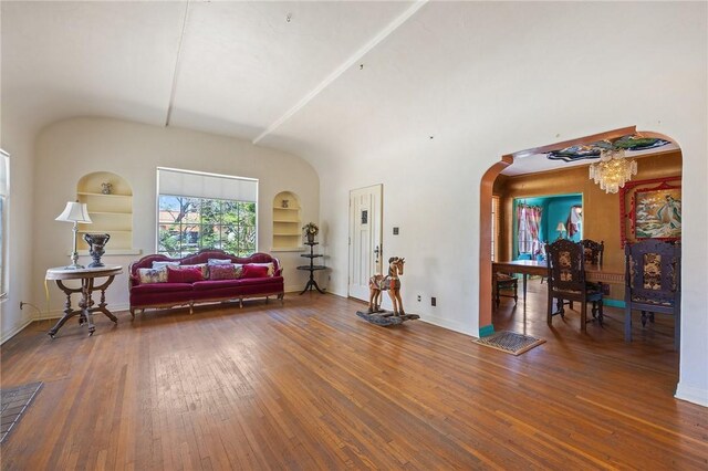 720 W La Habra Blvd, La Habra, CA 90631 - living area featuring built in features, arched walkways, wood finished floors, and a chandelier