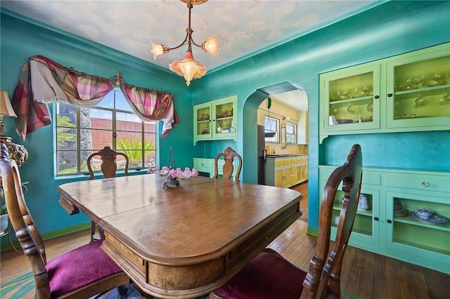 720 W La Habra Blvd, La Habra, CA 90631 - dining room featuring wood finished floors, arched walkways, and a chandelier