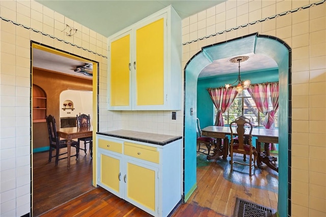 720 W La Habra Blvd, La Habra, CA 90631 - kitchen featuring tile counters, dark wood-style floors, arched walkways, and a chandelier