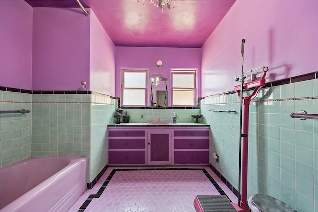 720 W La Habra Blvd, La Habra, CA 90631 - full bathroom featuring tile walls, inlaid floor details, wainscoting, a bath, and vanity