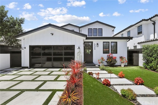 535 N Sierra Bonita Ave, Los Angeles, CA 90036 - modern inspired farmhouse featuring concrete driveway, a garage, and a front lawn