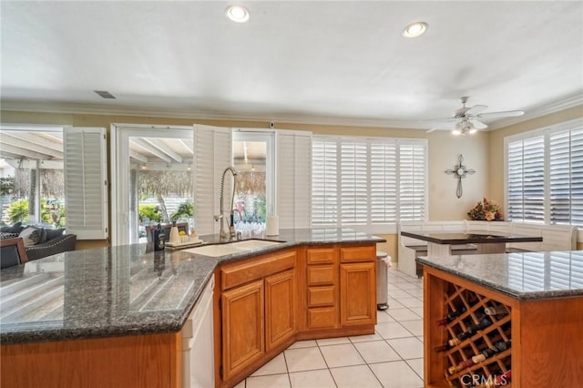 3723 Pinto Pl, Ontario, CA 91761 - kitchen with a sink, a kitchen island with sink, plenty of natural light, light tile patterned floors, and crown molding