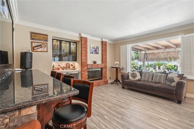 3723 Pinto Pl, Ontario, CA 91761 - living area featuring a brick fireplace, light wood-type flooring, ornamental molding, and baseboards