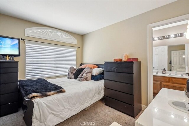3723 Pinto Pl, Ontario, CA 91761 - carpeted bedroom featuring connected bathroom and a sink