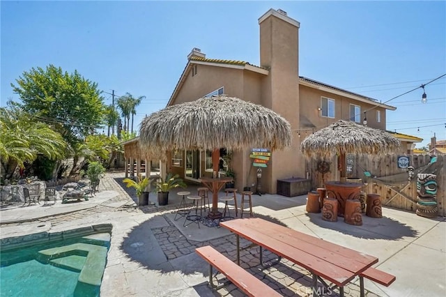 3723 Pinto Pl, Ontario, CA 91761 - rear view of property featuring a chimney, a patio area, stucco siding, and fence