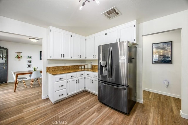 1388 E 39th St, San Bernardino, CA 92404 - kitchen with stainless steel fridge with ice dispenser, wood finished floors, white cabinetry, and baseboards