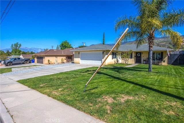 1388 E 39th St, San Bernardino, CA 92404 - ranch-style house featuring a garage, stucco siding, concrete driveway, a mountain view, and a front lawn